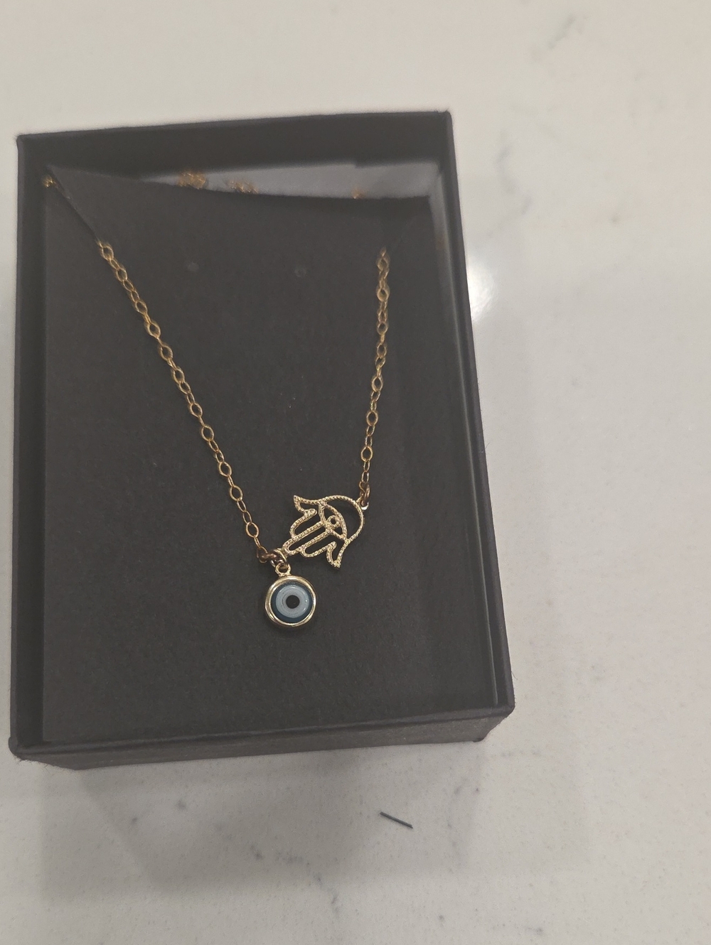 Gold Tone Hamsa Hand Necklace with Blue Evil Eye Pendant